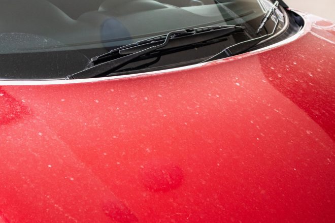 How To Tell When it Is Time To Detail Your Car: Red car with white water spots on the hood