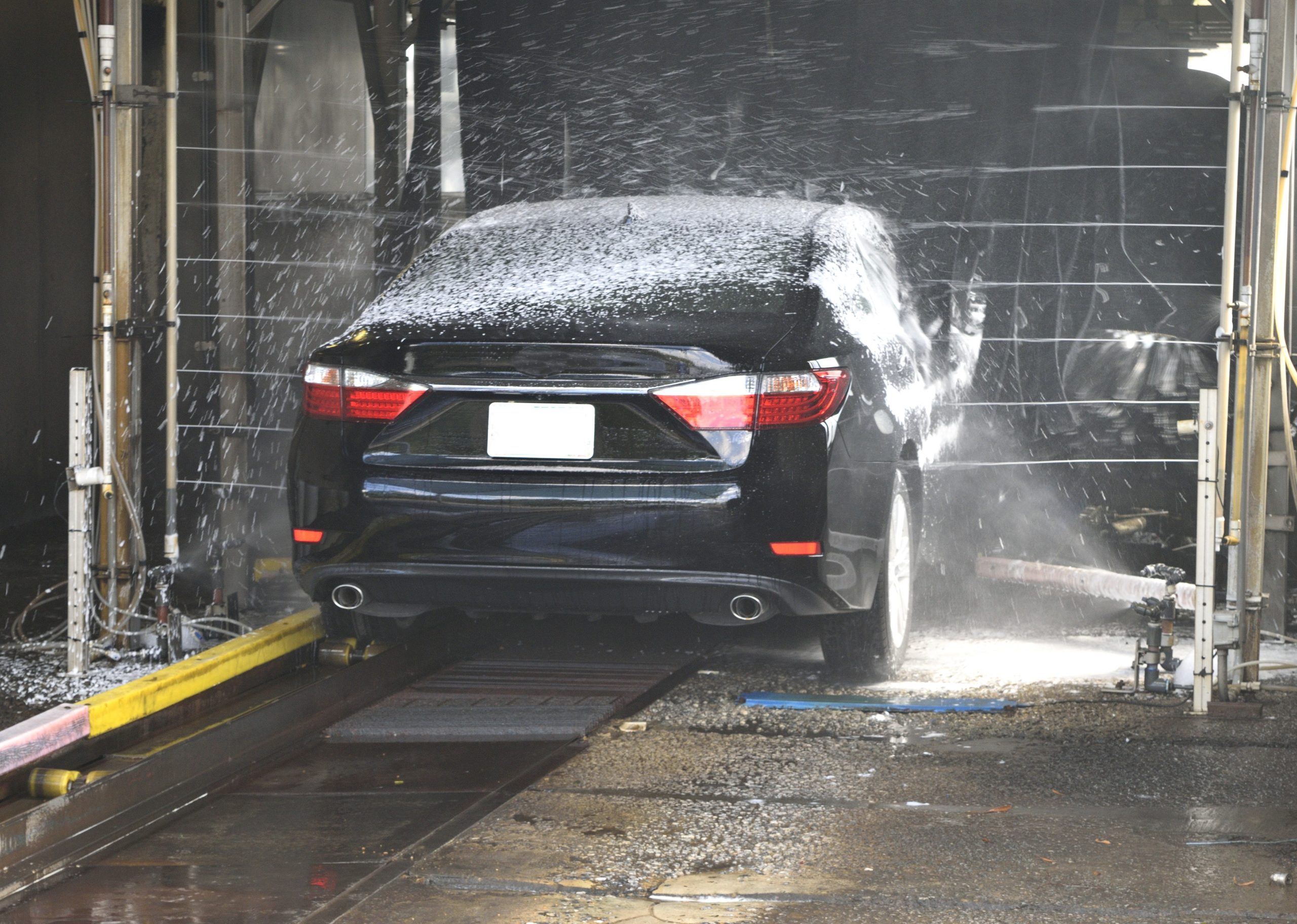 how often should you wash your car? black sedan going through an automatic car wash